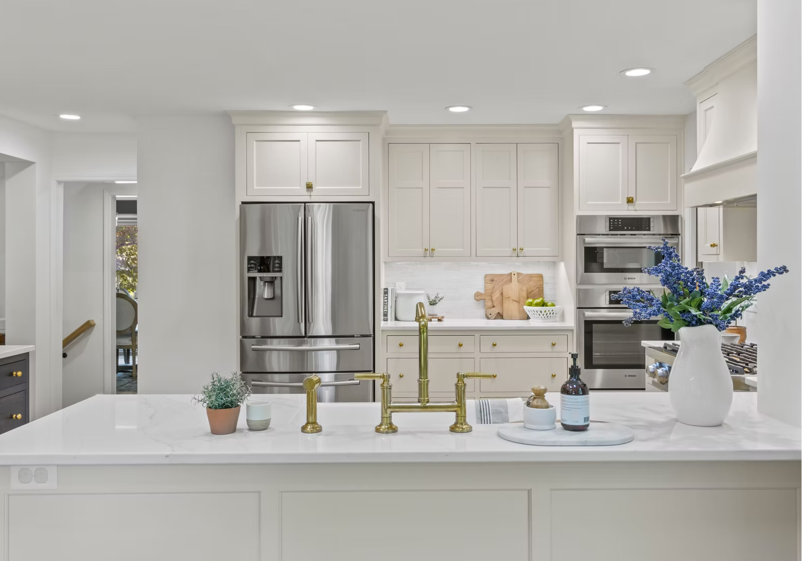 Bright white kitchen with brass fixtures